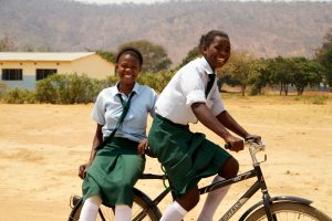 Girls in Africa riding a bicycle