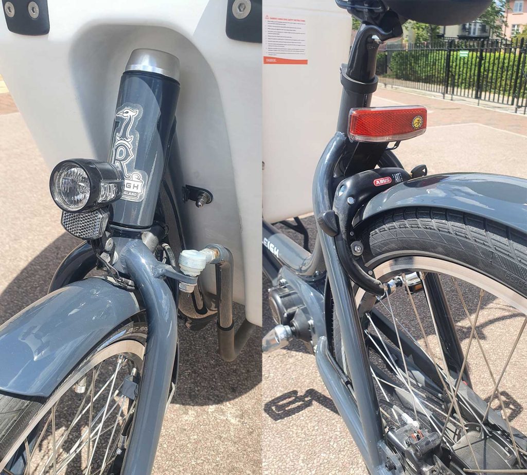Front and rear views of the Raleigh Pro Cargo Bike showing lights, wheel lock and mud guards